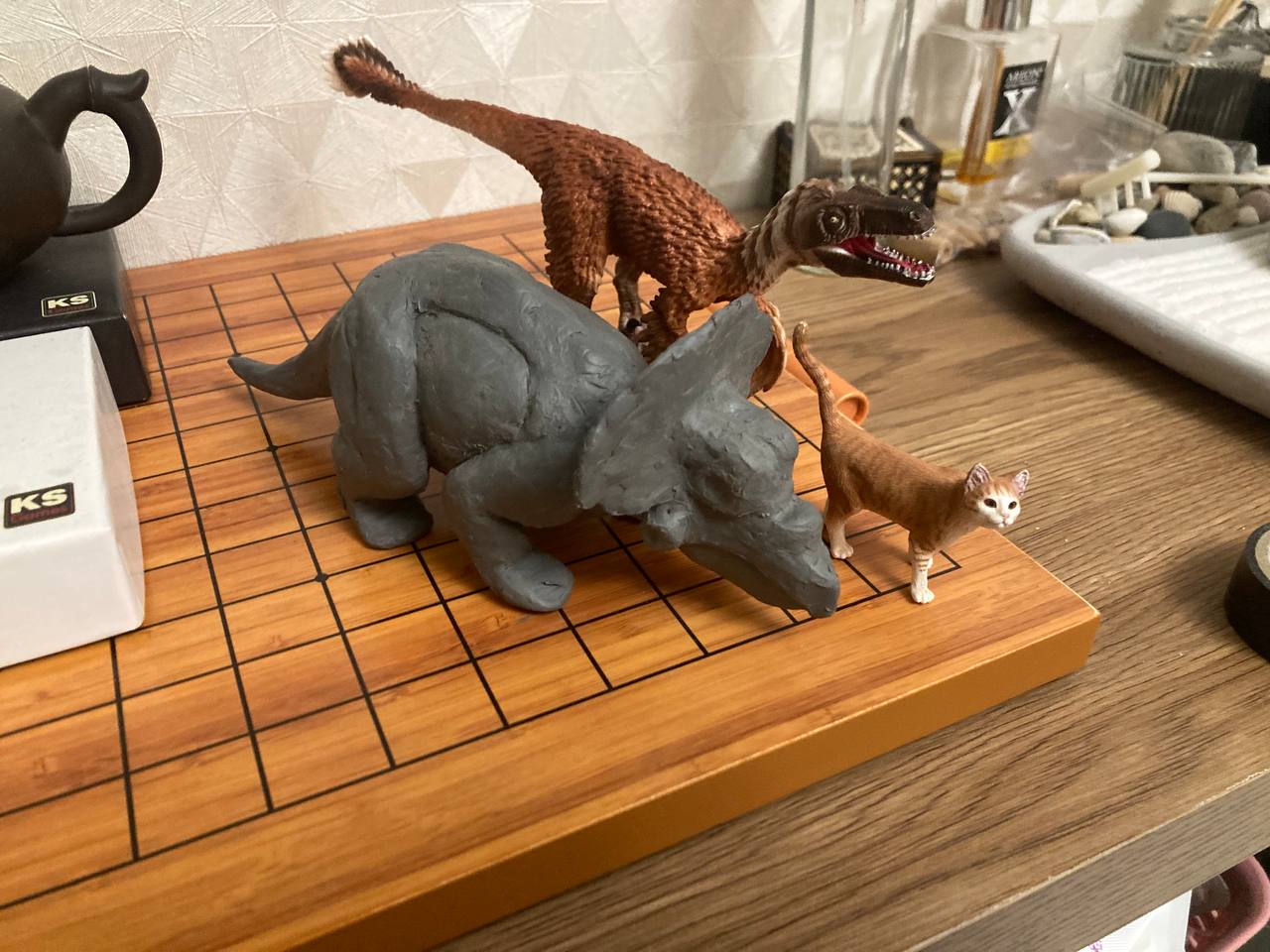 Handmade dinosaur sculptures arranged on a studio table